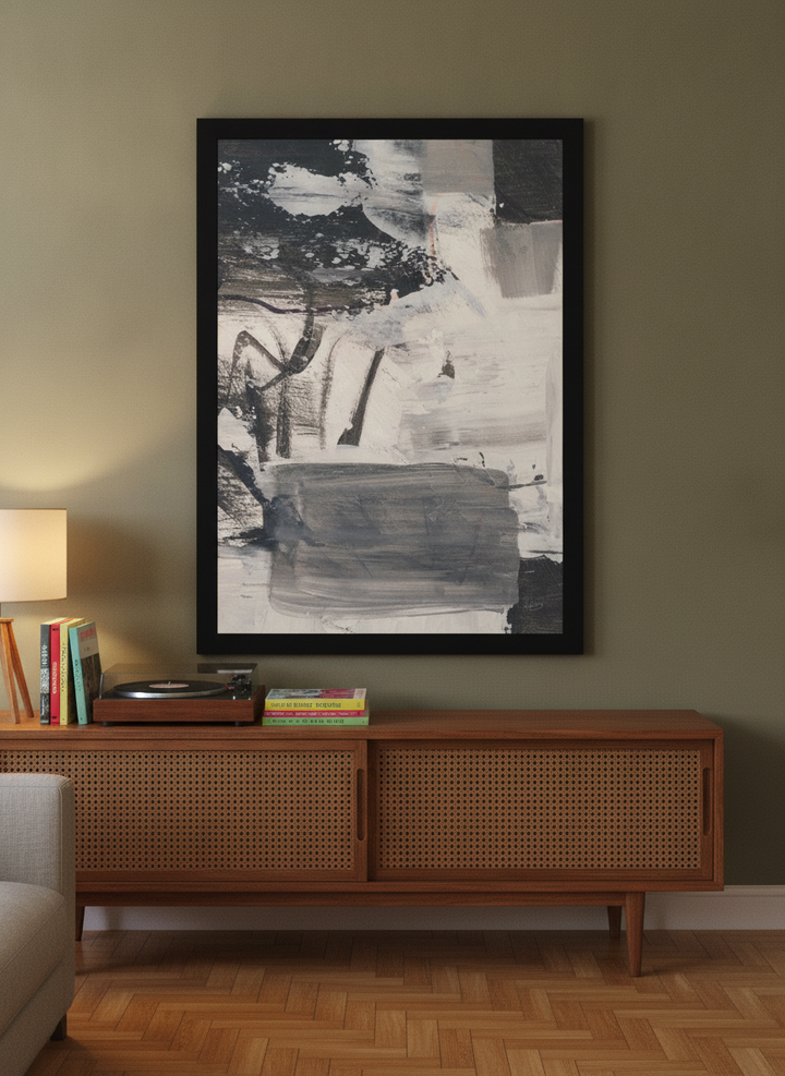 Modern wall art print standing on a sideboard in a mid-century living room