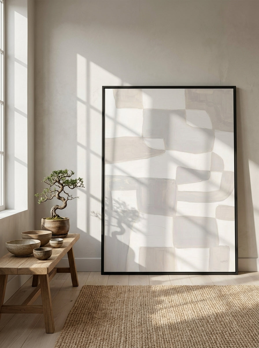 Oversized statement modern wall art print leaning against the wall in a warm Japandi bedroom