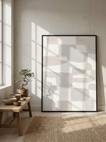 Oversized statement modern wall art print leaning against the wall in a warm Japandi bedroom