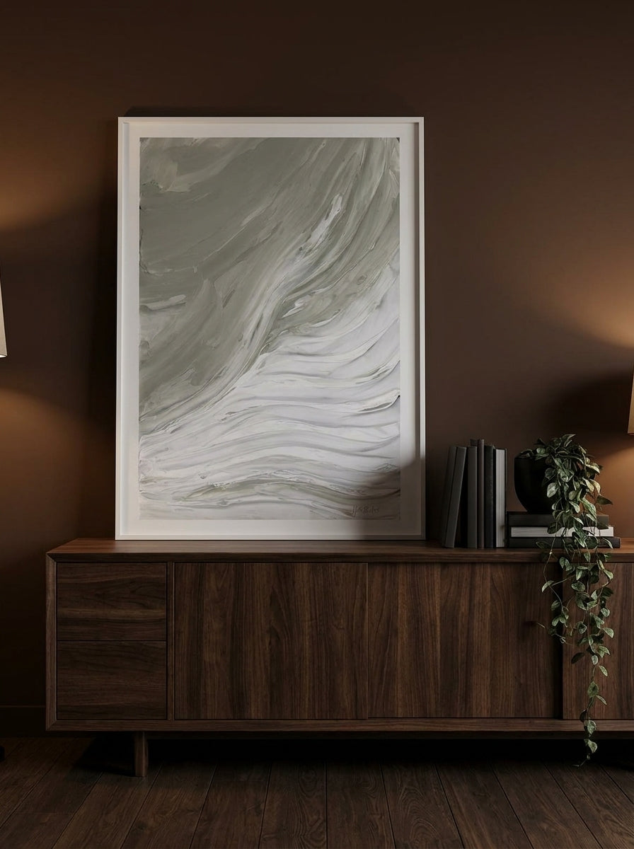 Modern wall art print standing on a sideboard in a moody bedroom