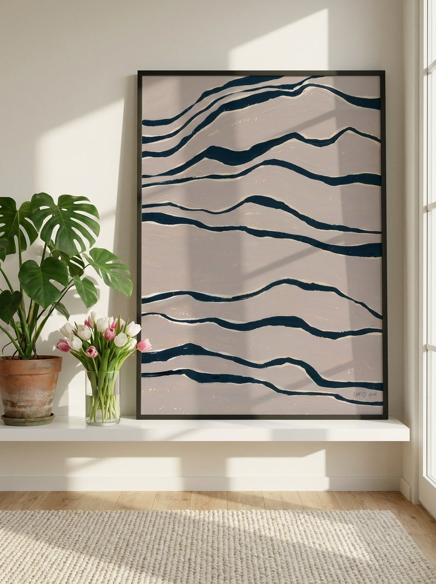 Modern wall art print standing on a shelf in a bright Scandinavian bedroom