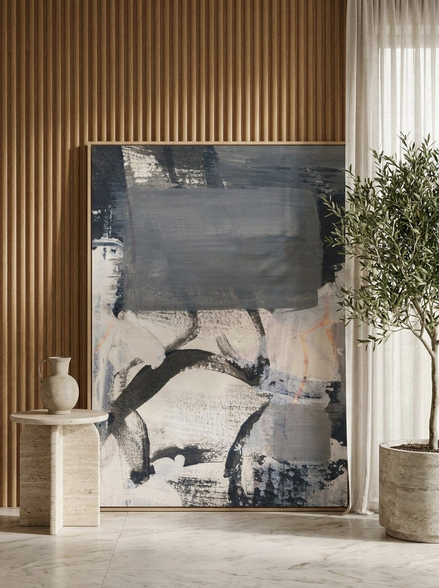 Oversized statement canvas wall art with a natural timber surround leaning against the wall in a luxe bedroom