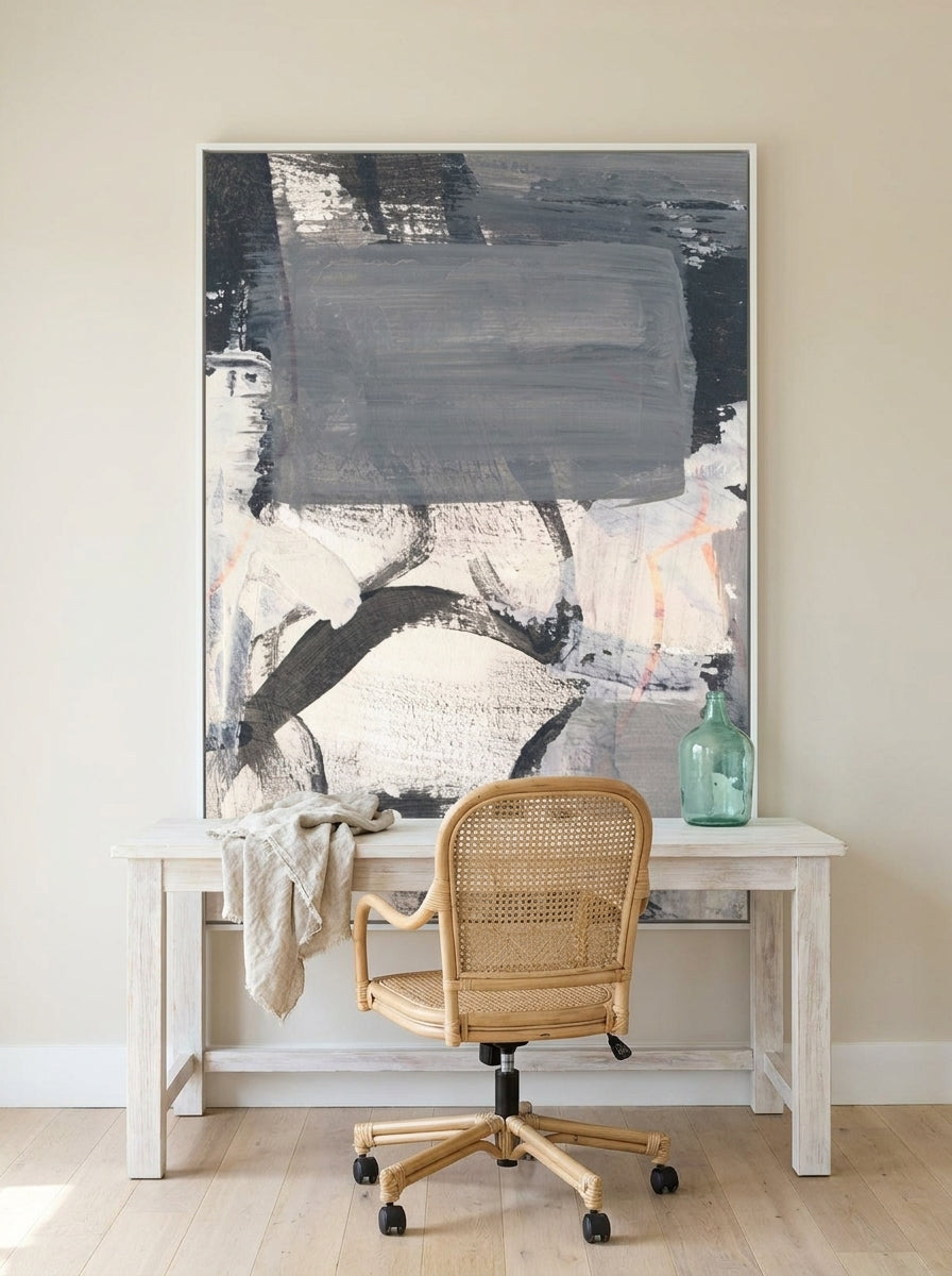 Canvas wall art with a white surround styled on the wall in a coastal home office