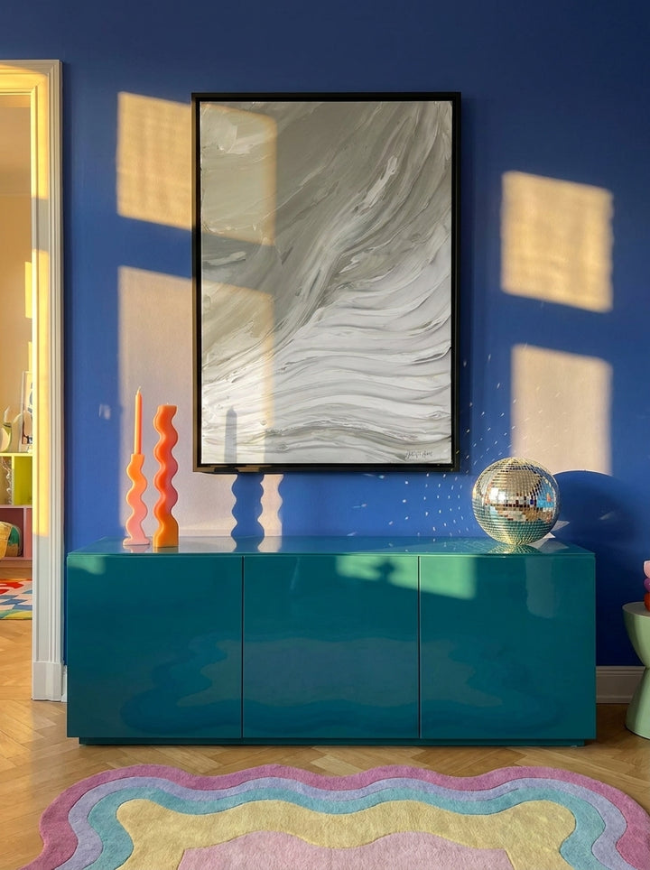 Canvas wall art with a black surround styled on the wall in a colourful eclectic living room