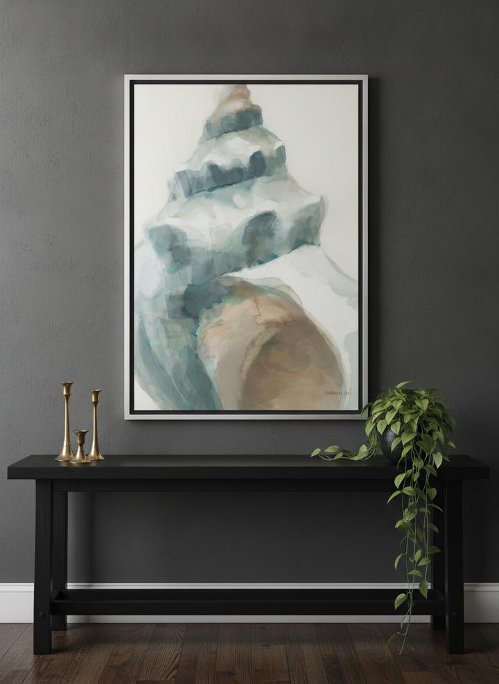 Canvas wall art with a silver leaf surround standing on a console in a moody home office