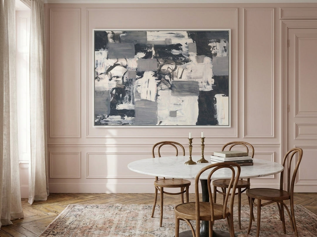 Oversized statement canvas wall art with a white surround styled on the wall in a Parisian dining room
