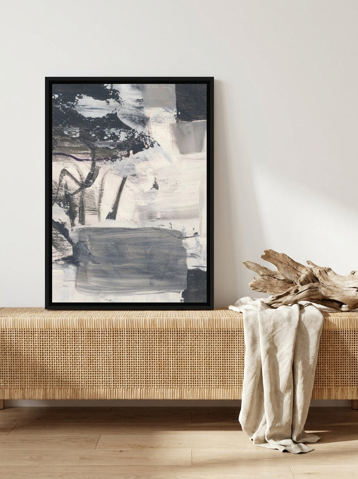 Canvas wall art with a black surround standing on a sideboard in a coastal living room