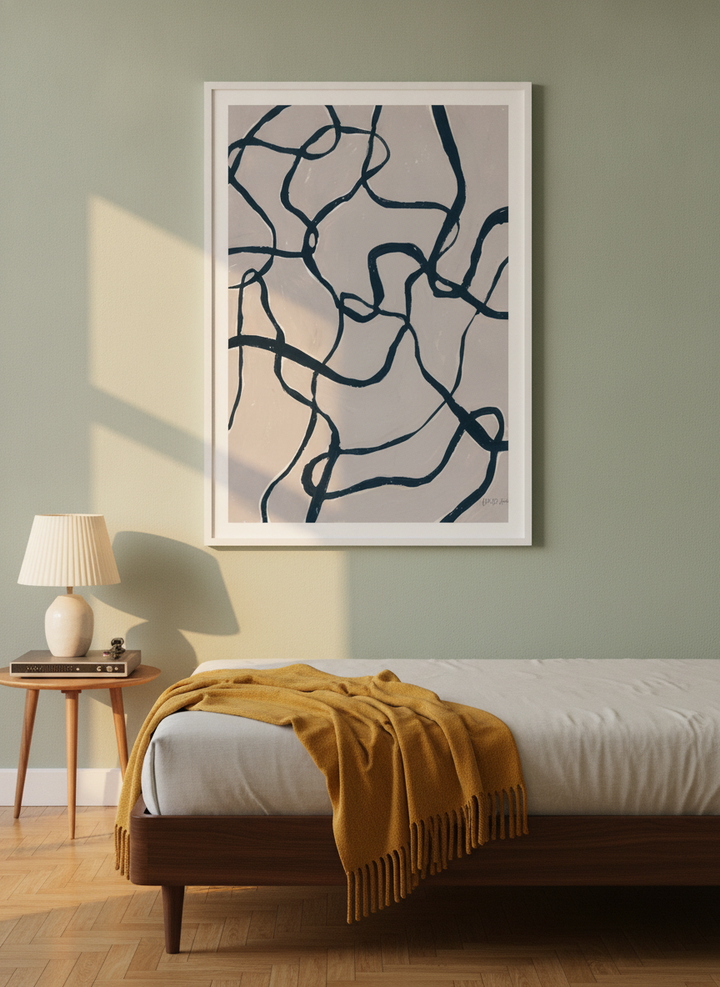 Modern wall art print styled on the wall in a mid-century bedroom