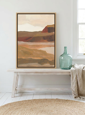 Canvas wall art with a natural timber surround standing on a console in a coastal home office