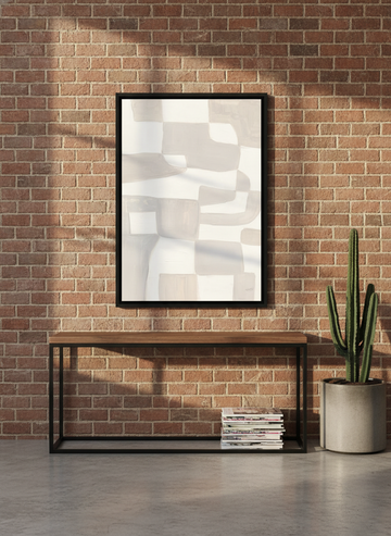 Canvas wall art with a black surround standing on a console in an industrial loft home office