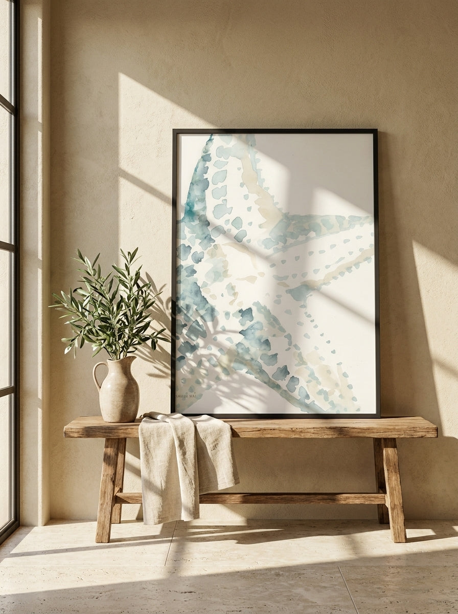 Modern wall art print standing on a bench in a Mediterranean bathroom