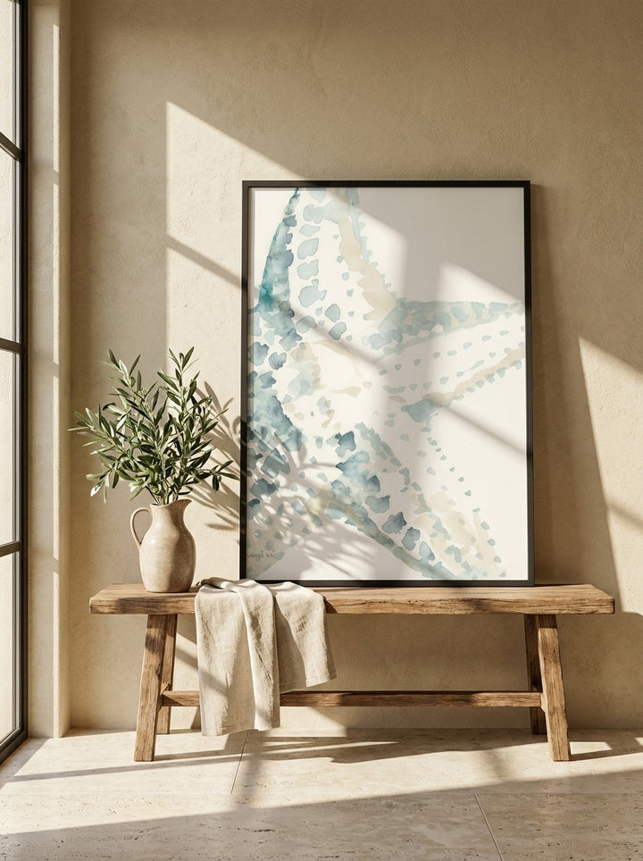 Modern wall art print standing on a bench in a Mediterranean bathroom