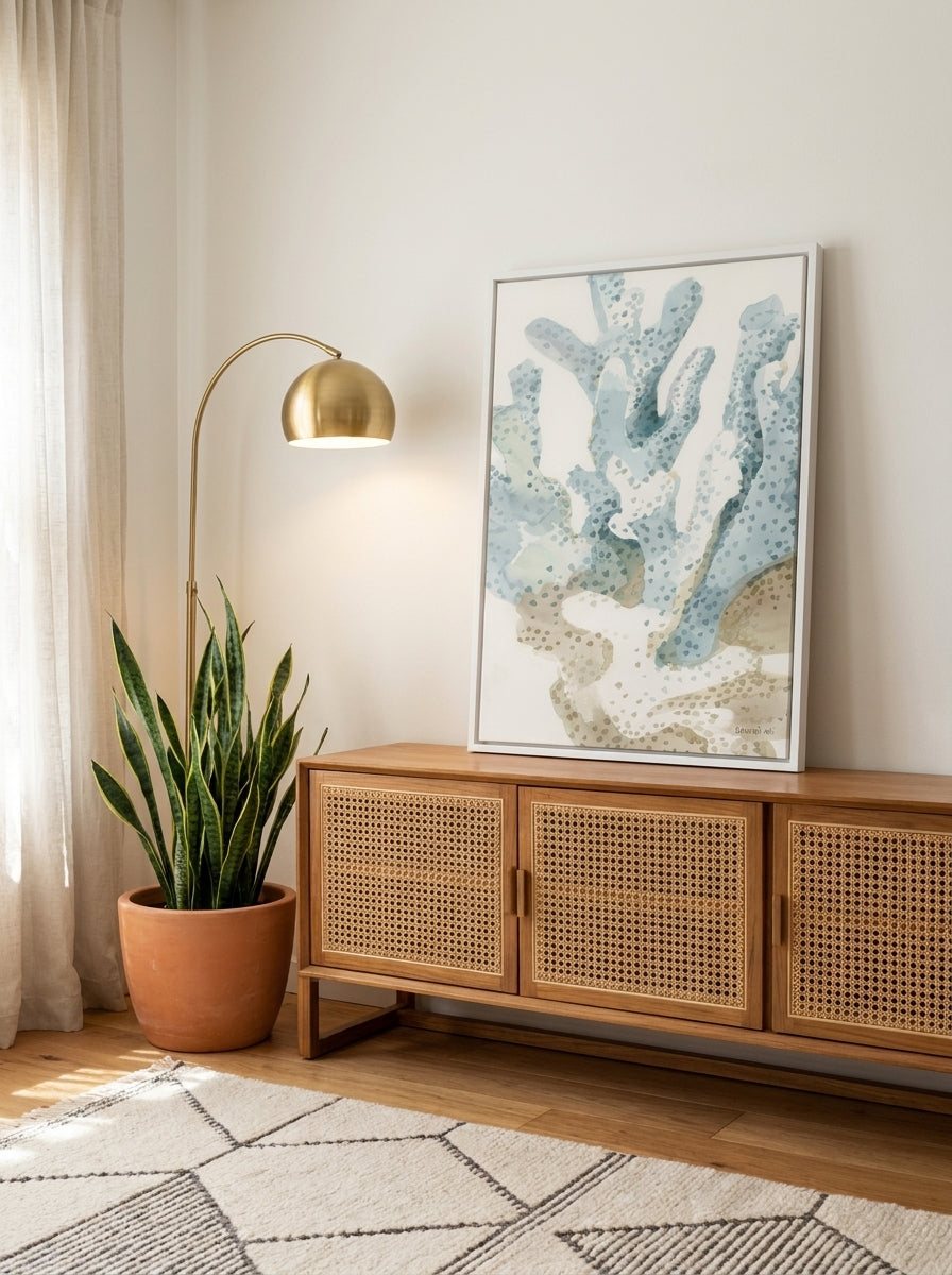 Canvas wall art with a white surround standing on a sideboard in a mid-century bedroom