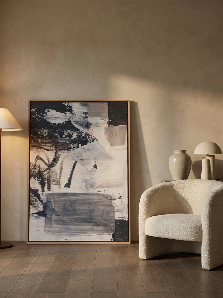 Oversized statement canvas wall art with a natural timber surround leaning against the wall in a luxe bedroom