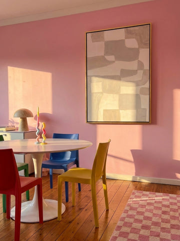 Canvas wall art with a gold leaf surround styled on the wall in a colourful eclectic dining room
