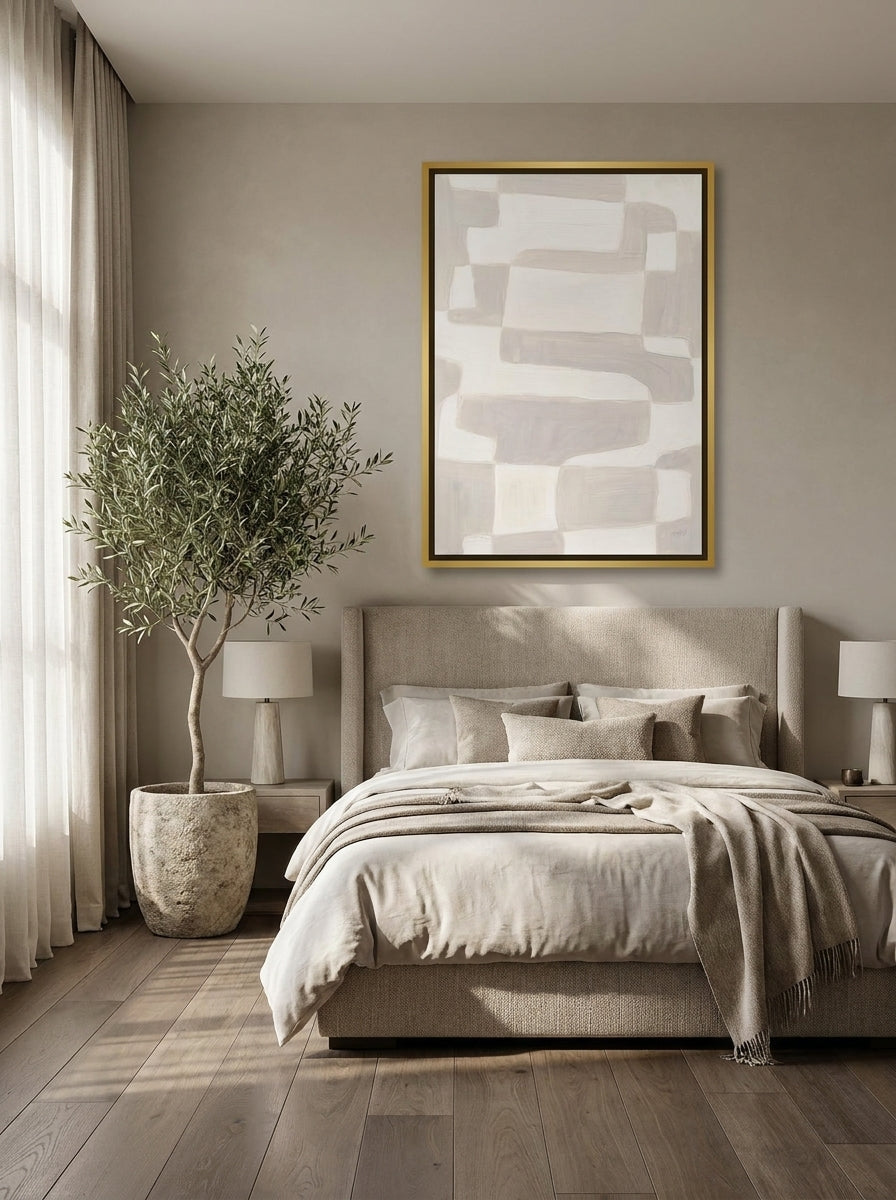 Canvas wall art with a gold leaf surround styled on the wall in a luxe bedroom
