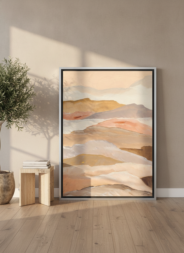 Oversized statement canvas wall art with a silver leaf surround leaning against the wall in a luxe dining room
