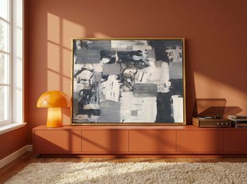 Canvas wall art with a gold leaf surround standing on a sideboard in a retro 70s living room