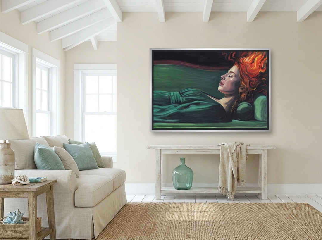 Oversized statement canvas wall art with a silver leaf surround styled on the wall in a coastal living room