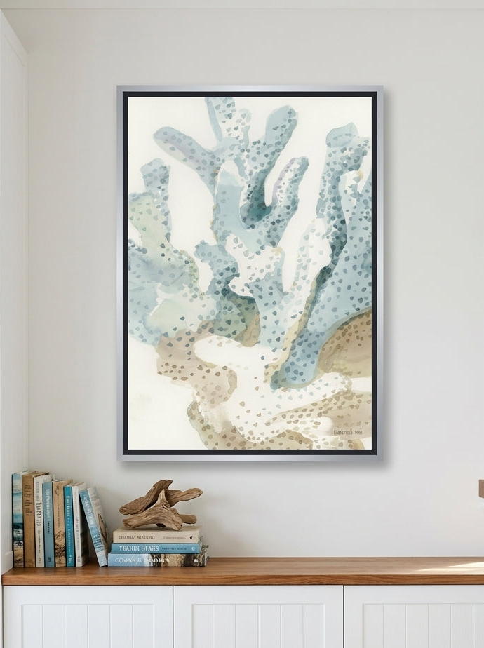 Canvas wall art with a silver leaf surround styled on the wall in a coastal kitchen