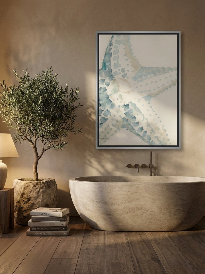 Canvas wall art with a silver leaf surround styled on the wall in a luxe bathroom