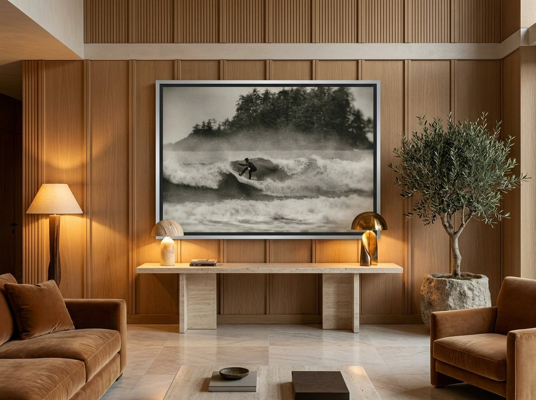 Oversized statement canvas wall art with a silver leaf surround styled on the wall in a luxe living room