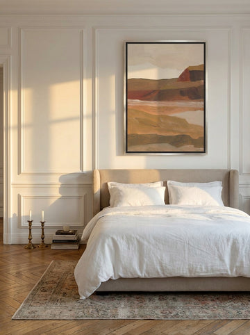 Canvas wall art with a silver leaf surround styled on the wall in a Parisian bedroom
