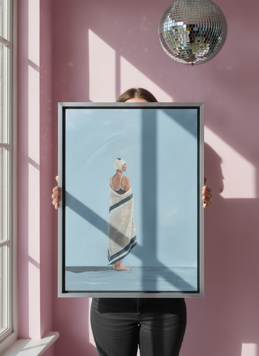 Person holding canvas wall art with a silver leaf surround in a colourful eclectic living room