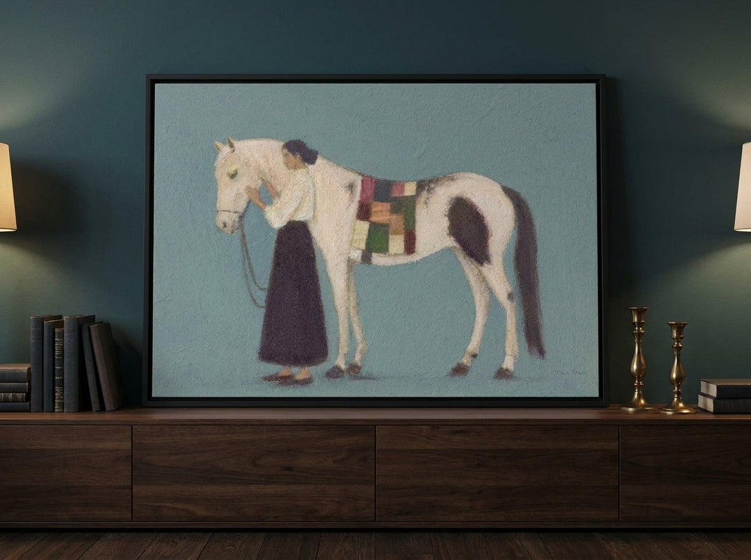 Canvas wall art with a black surround standing on a sideboard in a moody home office