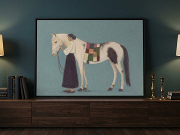 Canvas wall art with a black surround standing on a sideboard in a moody home office