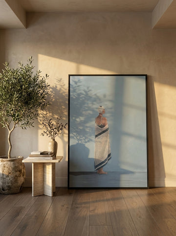 Oversized statement modern wall art print leaning against the wall in a luxe dining room