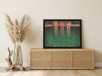 Modern wall art print standing on a sideboard in a coastal bathroom
