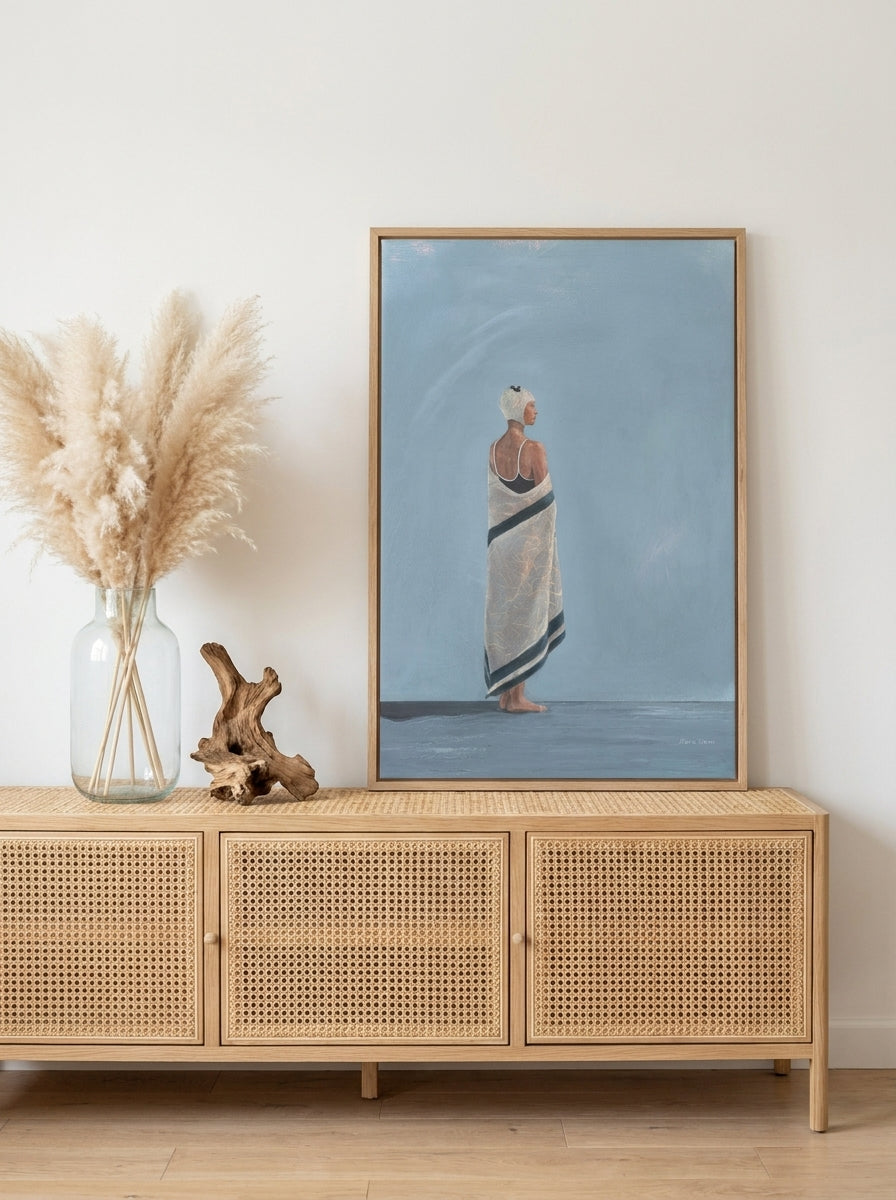 Modern wall art print standing on a sideboard in a coastal living room
