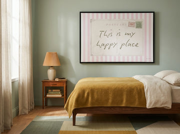 Canvas wall art with a black surround styled on the wall in a mid-century bedroom
