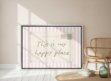 Canvas wall art with a silver leaf surround leaning against the wall in a coastal bathroom