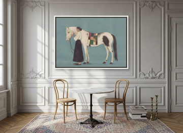 Oversized statement canvas wall art with a white surround styled on the wall in a Parisian dining room