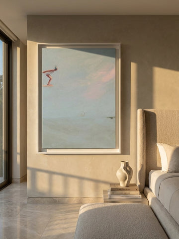 Oversized statement canvas wall art with a white surround styled on the wall in a luxe bedroom
