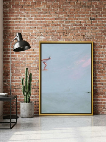 Canvas wall art with a gold leaf surround leaning against the wall in an industrial loft living room