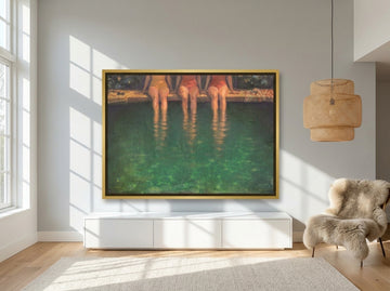 Oversized statement canvas wall art with a gold leaf surround styled on the wall in a bright Scandinavian living room