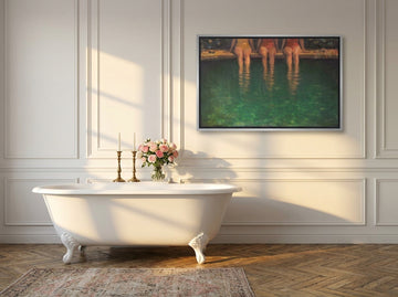Canvas wall art with a silver leaf surround styled on the wall in a Parisian bathroom