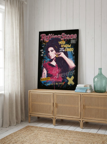 Stretched canvas wall art standing on a sideboard in a coastal bedroom