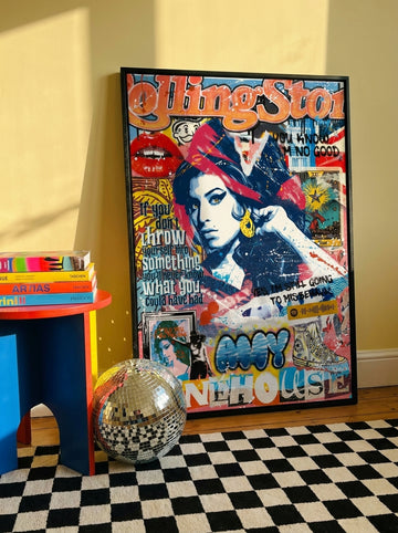 Oversized statement modern wall art print leaning against the wall in a colourful eclectic bedroom