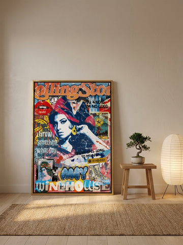 Oversized statement canvas wall art with a gold leaf surround leaning against the wall in a warm Japandi bedroom