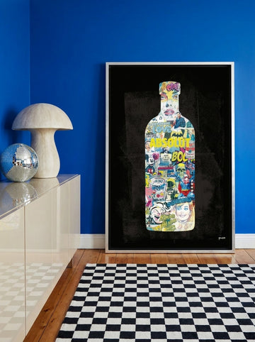 Canvas wall art with a silver leaf surround standing on a sideboard in a colourful eclectic living room