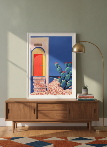 Modern wall art print standing on a sideboard in a mid-century home office