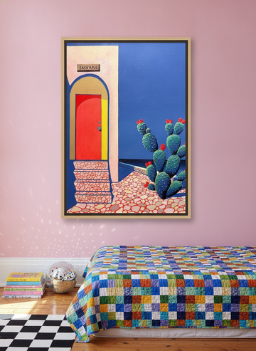 Oversized statement canvas wall art with a natural timber surround styled on the wall in a colourful eclectic bedroom
