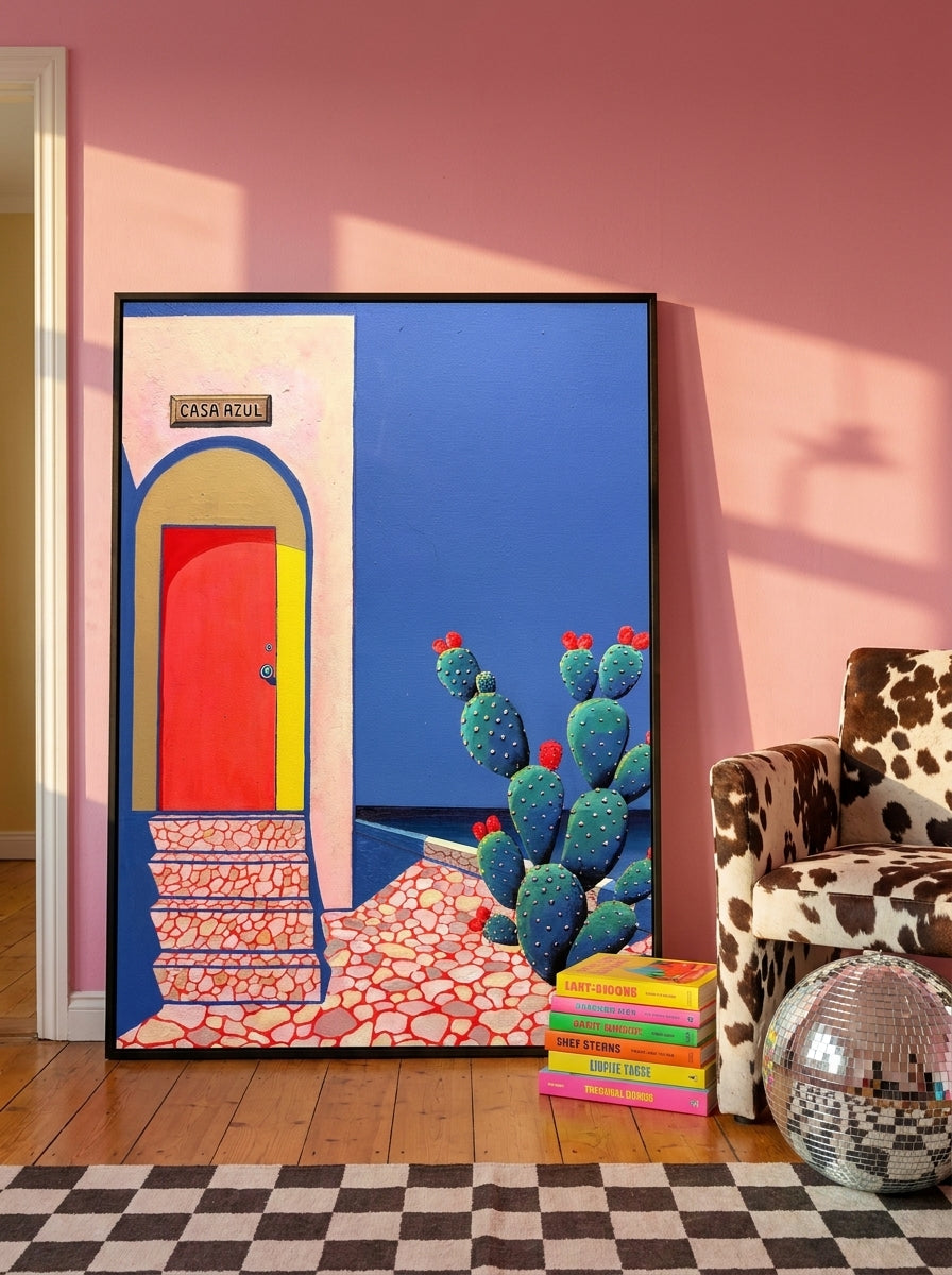 Oversized statement modern wall art print leaning against the wall in a colourful eclectic dining room