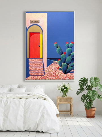 Oversized statement canvas wall art with a white surround styled on the wall in a bright Scandinavian bedroom