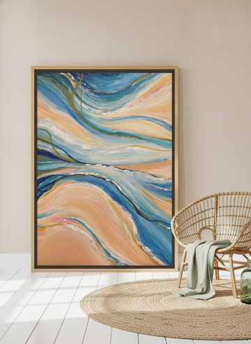 Oversized statement canvas wall art with a natural timber surround leaning against the wall in a coastal living room