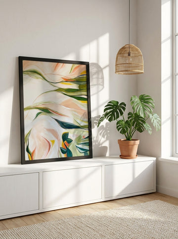 Modern wall art print standing on a sideboard in a bright Scandinavian bedroom
